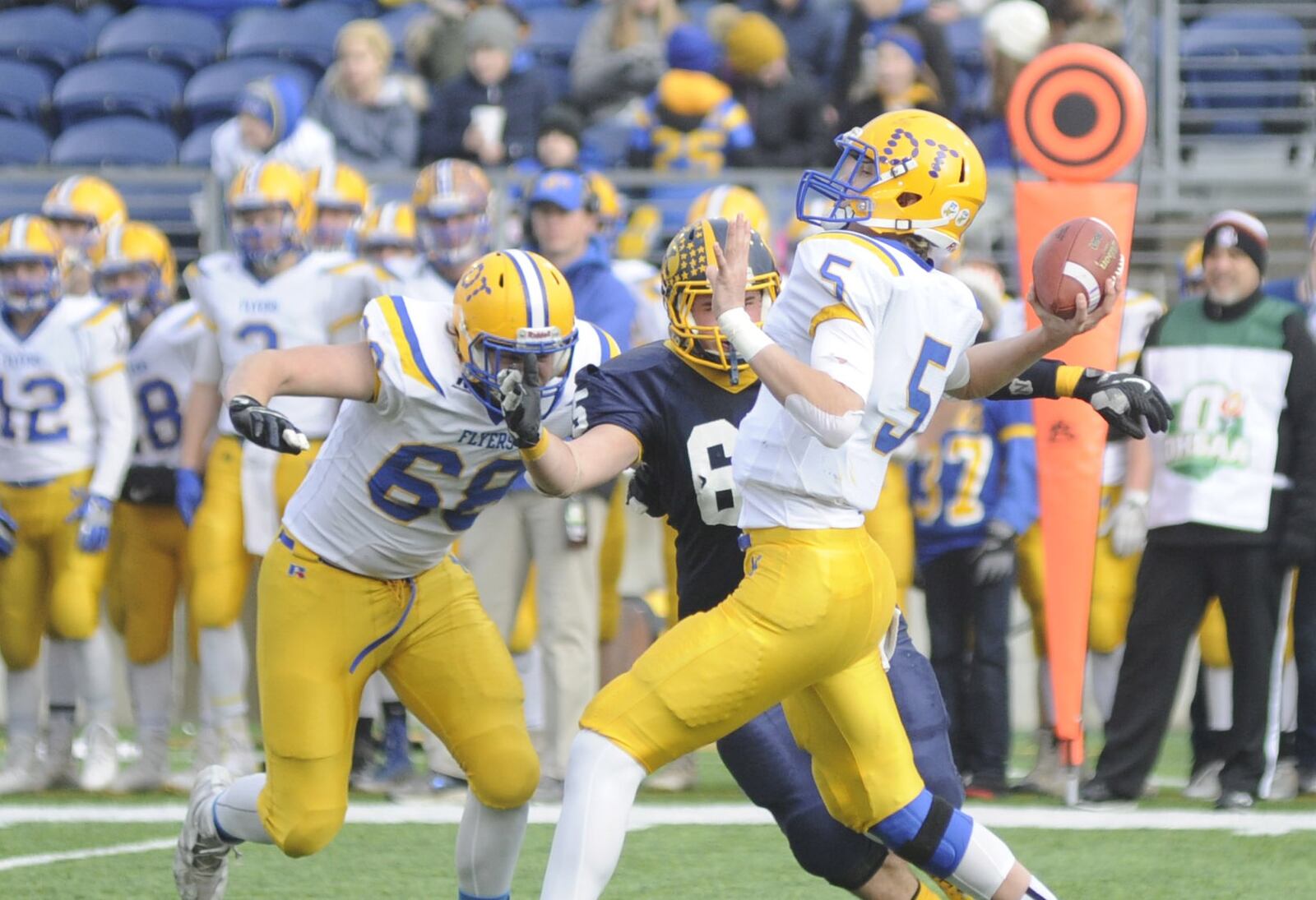 Marion Local Qb Nathan Bruns unloads as Eric Schlarman (left) blocks. Kirtland defeated Marion Local 16-7 in the D-VI high school football state championship at Canton’s Tom Benson Hall of Fame Stadium on Friday, Nov. 30, 2018. MARC PENDLETON / STAFF