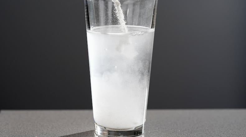 Electrolyte supplements are poured into glass of water Tuesday, Feb. 24, 2026, in Nashville, Tenn. (AP Photo/George Walker IV)