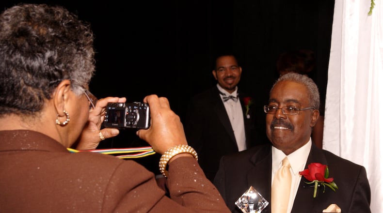 With incoming President of the Dayton Urban League Sheldon Mitchell (center) looking on, Dayton Weekly News reporter Barbara Vinzant (left) takes a picture of Dayton Weekly News CEO and honoree Don Black during the 11th Annual Dayton Urban League Gala at the Dayton Art Institute, Friday, November 7, 2008.