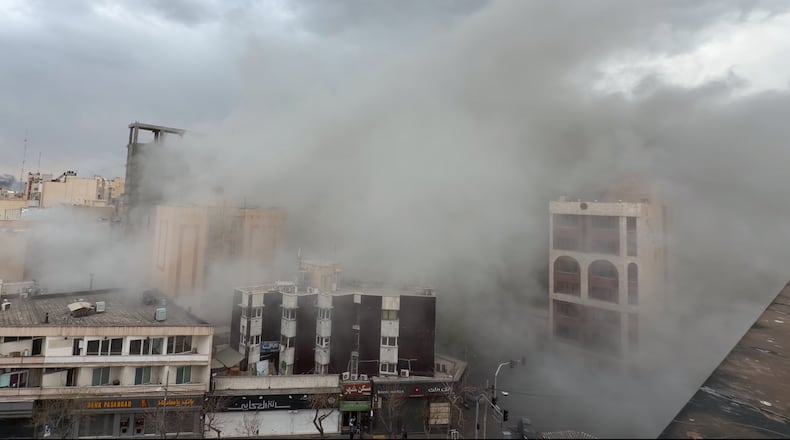 Smoke engulfs a street after a strike in Tehran, Iran, Monday, March 2, 2026. (AP Photo/Mohsen Ganji)