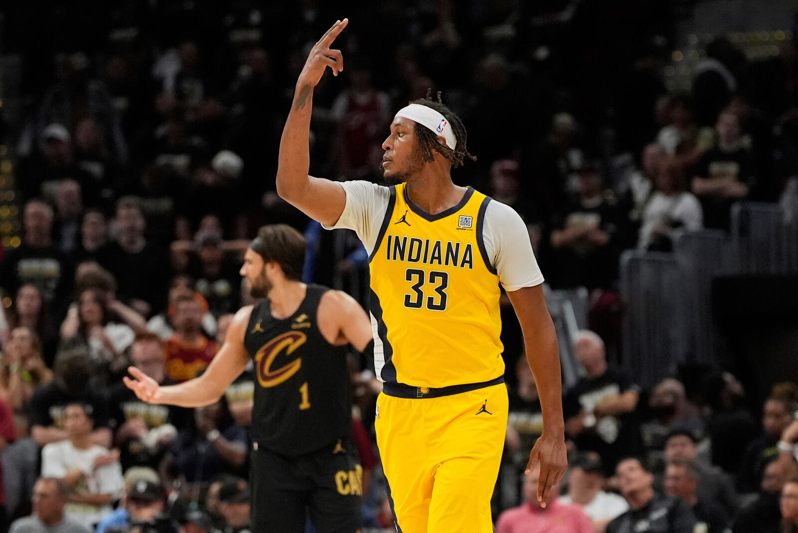 Indiana Pacers center Myles Turner, right, gestures after scoring as Cleveland Cavaliers guard Max Strus reacts during the second half in Game 5 of an Eastern Conference semifinal NBA basketball playoff Tuesday, May 13, 2025, in Cleveland. (AP Photo/Sue Ogrocki)