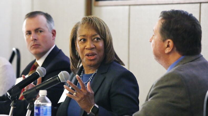 State Representatives Robert Sprague, left, and Jeff Rezabek, right, listen as Helen Jones-Kelley, executive director of the Alcohol, Drug Addiction and Mental Health Services for Montgomery County, makes a point about the opioid crisis during an Impact Ohio discussion on Thursday. TY GREENLEES / STAFF