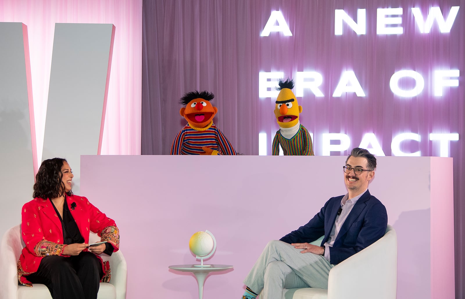 Sal Perez, executive producer and VP of Sesame Street at Sesame Workshop, right, and Versha Sharma, editor-in-chief at Teen Vogue, talk to Burt and Ernie after Sesame Workshop won the Elevate Prize Foundation's Catalyst Award, Wednesday, May 14, 2025, in Miami Beach, Fla. (AP Photo/Michael Laughlin)