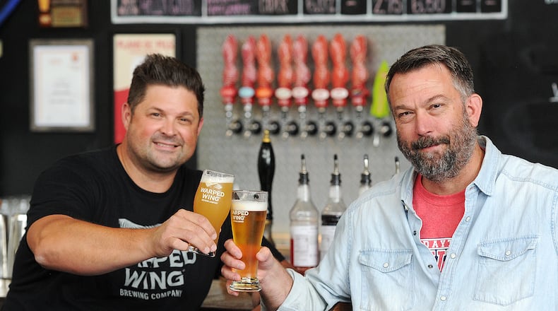 Warped Wing Brewing Company owners, Nick Bowman, left, and John Haggerty at the 26 Wyandot St. location in Dayton.
MARSHALL GORBY\STAFF