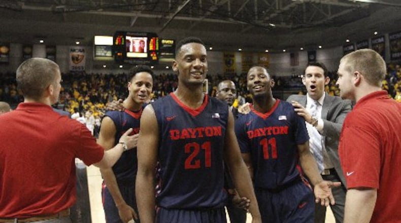 Dayton’s Dyshawn Pierre and the Flyers leave the court after a victory against Virginia Commonwealth on Saturday, Feb. 28, 2015, at the Siegel Center in Richmond, Va. David Jablonski/Staff
