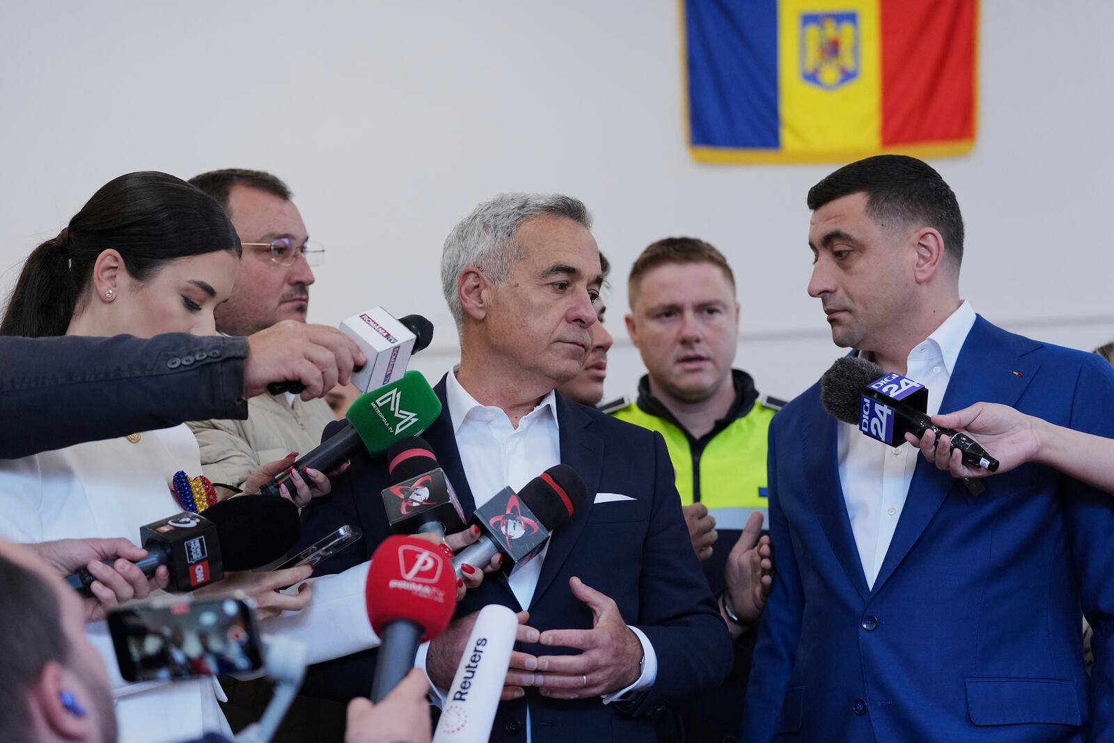 Presidential candidate George Simion, right, and Calin Georgescu, winner of the first round of last year's annulled election, speak to media after casting their votes in the second round of the country's presidential election redo in Mogosoaia, Romania, Sunday, May 18, 2025. (AP Photo/Andreea Alexandru)