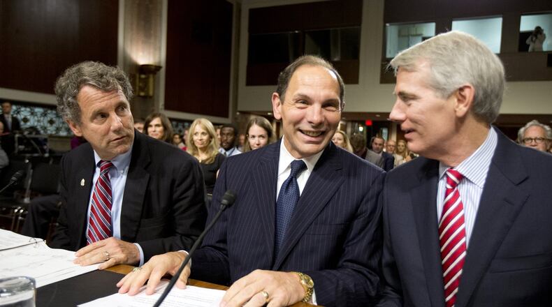 Veterans Affairs Secretary nominee Robert McDonald of Ohio is flanked by Sens. Sherrod Brown, D-Ohio, left, and Rob Portman, R-Ohio, right, ahead of a Senate Veterans’ Affairs Committee hearings to examine his nomination to be Secretary of Veterans Affairs on Capitol Hill in Washington, Tuesday, July 22, 2014. (AP Photo)
