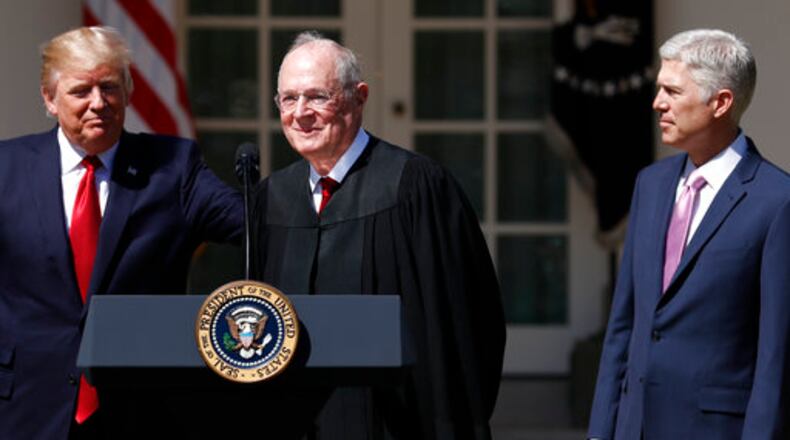 President Donald Trump, left, Supreme Court Justice Anthony Kennedy, center, and Justice Neil Gorsuch participate in a public swearing-in ceremony for Gorsuch in the Rose Garden of the White House White House in Washington, Monday, April 10, 2017. (AP Photo/Carolyn Kaster)