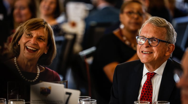 Fran and Gov. Mike DeWine react to comments by the MC of the 2021 Dayton Walk of Fame celebration was held Tuesday morning Oct. 12, 2021 at Sinclair Community College. The Walk of Fame recognizes the lives of accomplishments of individuals from the Greater Miami Valley area. Some notables from Tuesday event are, Gov. Mike DeWine and Springfield entertainer, John Legend. JIM NOELKER/STAFF