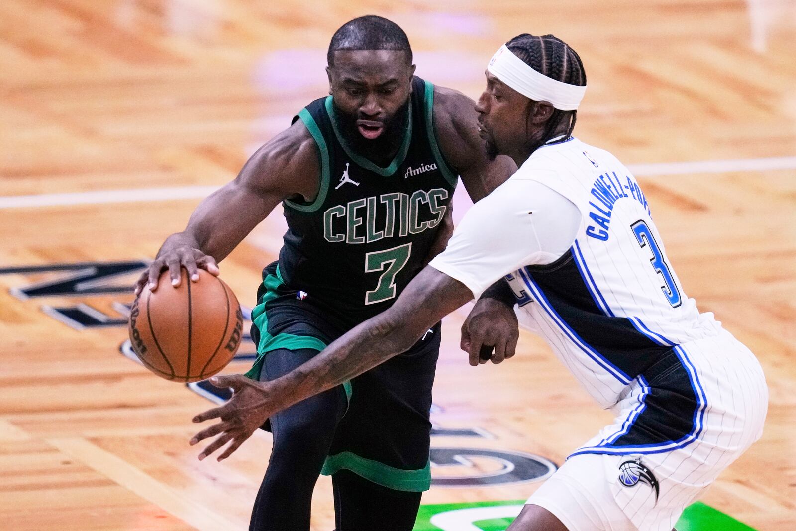 Boston Celtics guard Jaylen Brown (7) drives to the basket against Orlando Magic guard Kentavious Caldwell-Pope (3) during the first half in Game 5 of a first-round NBA playoff basketball series, Tuesday, April 29, 2025, in Boston. (AP Photo/Charles Krupa)