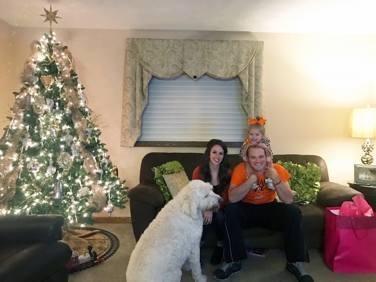 The Swank family — Katie, Travis, Samie on dad’s back and dog Gus — at family home in rural Darke County southwest of Versailles. TOM ARCHDEACON/STAFF