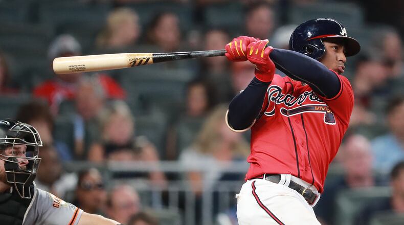 Ozzie Albies hits a RBI single to score Ronald Acuna Jr. for a 2-0 lead. Curtis Compton/ccompton@ajc.com