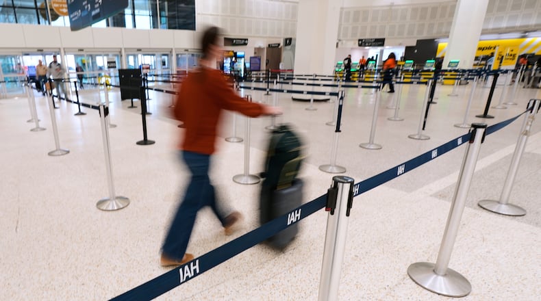 A traveler walks through TSA security lines at George Bush Intercontinental Airport on Monday, March 30, 2026, in Houston. (AP Photo/Ashley Landis)