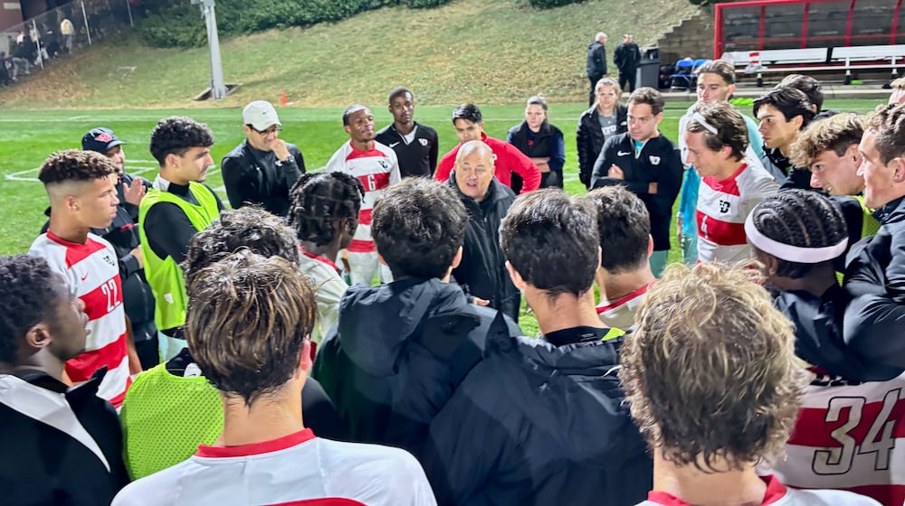 Dayton coach Dennis Currier talks to the team after a victory against Davidson in the A-10 tournament quarterfinals on Friday, Nov. 8, 2024, at Baujan Field in Dayton. David Jablonski/Staff