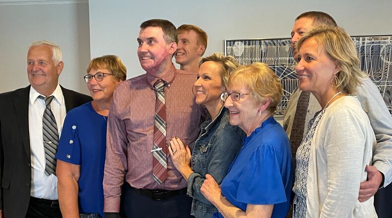 Kevin Pleiman (center) gets his picture taken with his family during a recent event honoring trauma survivors who were treated at Miami Valley Hospital's Level I Trauma Center. SAM WILDOW\STAFF