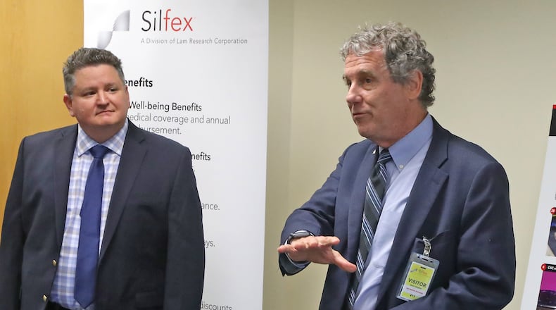 File - Senator Sherrod Brown speaks to the media about the recently passed CHIPS Act as Silfex, Inc General Manager Rob Skrobak listens Wednesday, Oct. 5, 2022. BILL LACKEY/STAFF