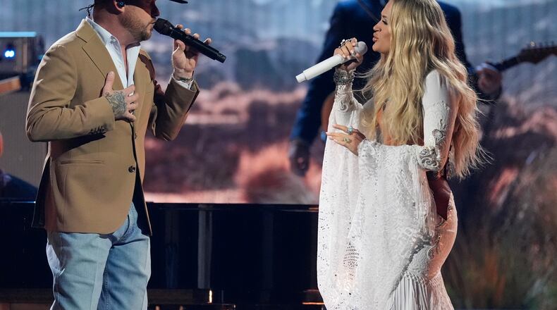 Cody Johnson, left, and Carrie Underwood perform during the 58th Annual CMA Awards on Wednesday, Nov. 20, 2024, at Bridgestone Arena in Nashville, Tenn. (AP Photo/George Walker IV)