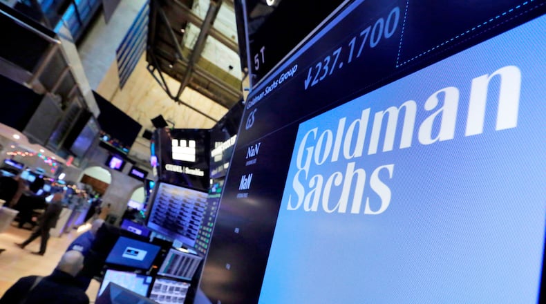 FILE - In this Dec. 13, 2016, file photo, the logo for Goldman Sachs appears above a trading post on the floor of the New York Stock Exchange. (AP Photo/Richard Drew, File)