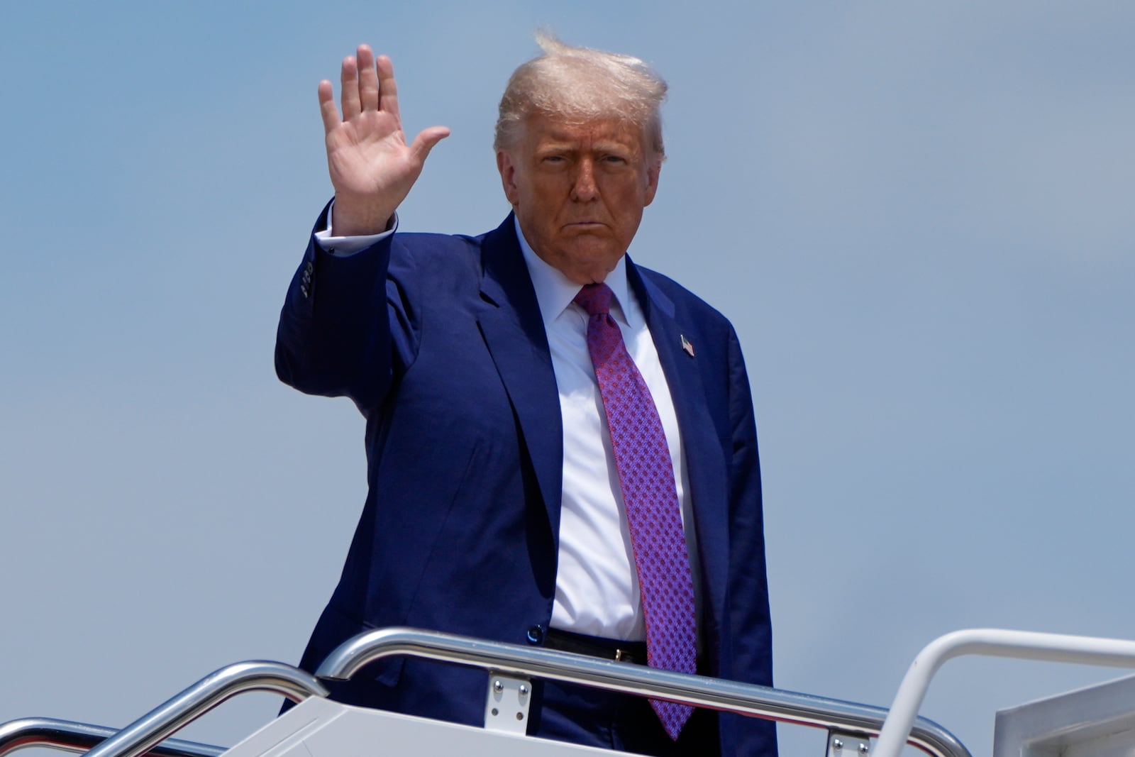 President Donald Trump waves as he boards Air Force One, Tuesday, June 10, 2025, at Joint Base Andrews, Md. (AP Photo/Alex Brandon)