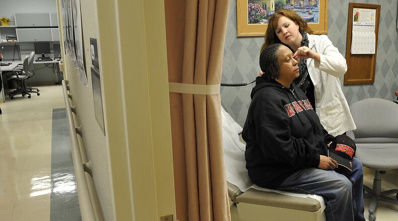 Heather Vince, nurse manager at the Springfield Community Based Outpatient Clinic, operated by the Department of Veterans Affairs, examines Myra Gaskins in 2013. Gaskins is a Desert Storm veteran from Springfield. Bill Lackey/Staff