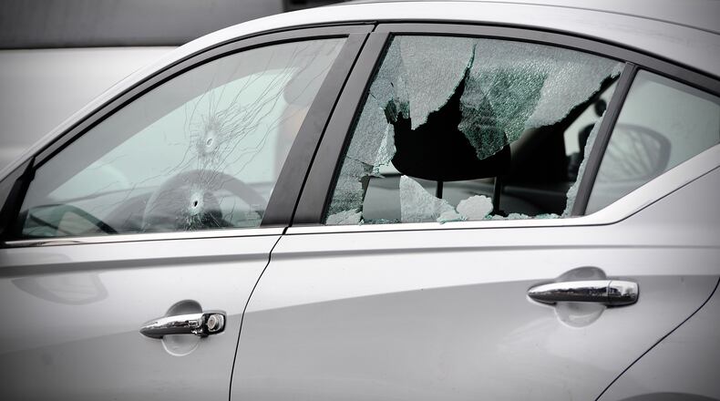 Dayton police found a silver car with multiple bullets holes shortly after 911 dispatchers received reports of people shooting at each other from vehicles on Wednesday, Dec. 29, 2021. MARSHALL GORBY / STAFF