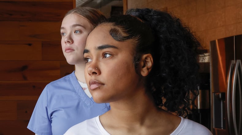 Omaria Ali, front, and Hannah Mills, juniors at the School of Innovation (SOI), pose for a portrait on Wednesday, December 3, 2025, at COhatch Springfield. Both students expressed frustration that the school is closing in 2026. JOSEPH COOKE/STAFF