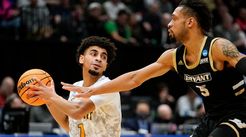 Wright State guard Trey Calvin (1) drives past Bryant's Charles Pride (5) during the second half of a First Four game in the NCAA men's college basketball tournament, Wednesday, March 16, 2022, in Dayton, Ohio. (AP Photo/Jeff Dean)