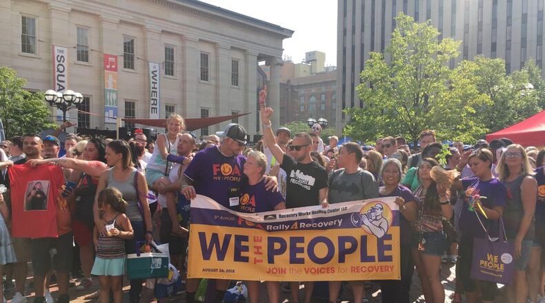 The work of Families of Addicts and other organizations in the Dayton region to provide recovery support to thousands of people over the last several years was one of the things credited by the New York Times in making a dent on the opioid epidemic. FOA held its fifth annual Rally For Recovery on Courthouse Square last August. Its founder, Lori Erion is at center. STAFF PHOTO BY KATIE WEDELL