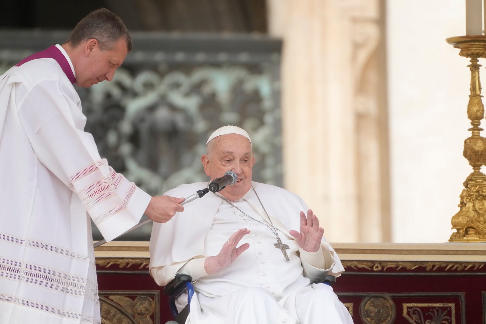 Monsignor Massimiliano Matteo Boiardi, left, holds the microphone for Pope Francis as he wishes happy Palm Sunday and Easter Festivities to the faithful who attended the mass on Palm Sunday in St. Peter's Square at The Vatican, Sunday, April 13, 2025. (AP Photo/Gregorio Borgia)