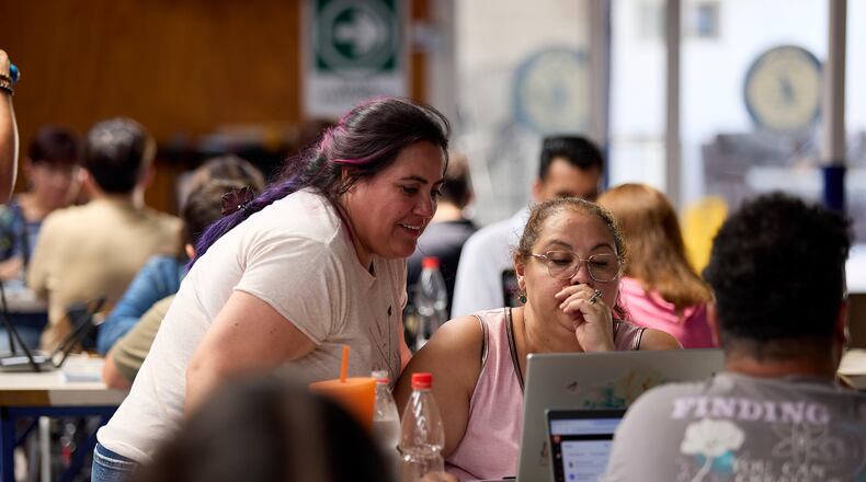 Rose Marie Pilgrim Mellis and Andrea Saavedra work through prompts together at the Quili.AI headquarters Jan. 31, 2026, in Quilicura, Chile. (Jota Velasquez/Tombras via AP)
