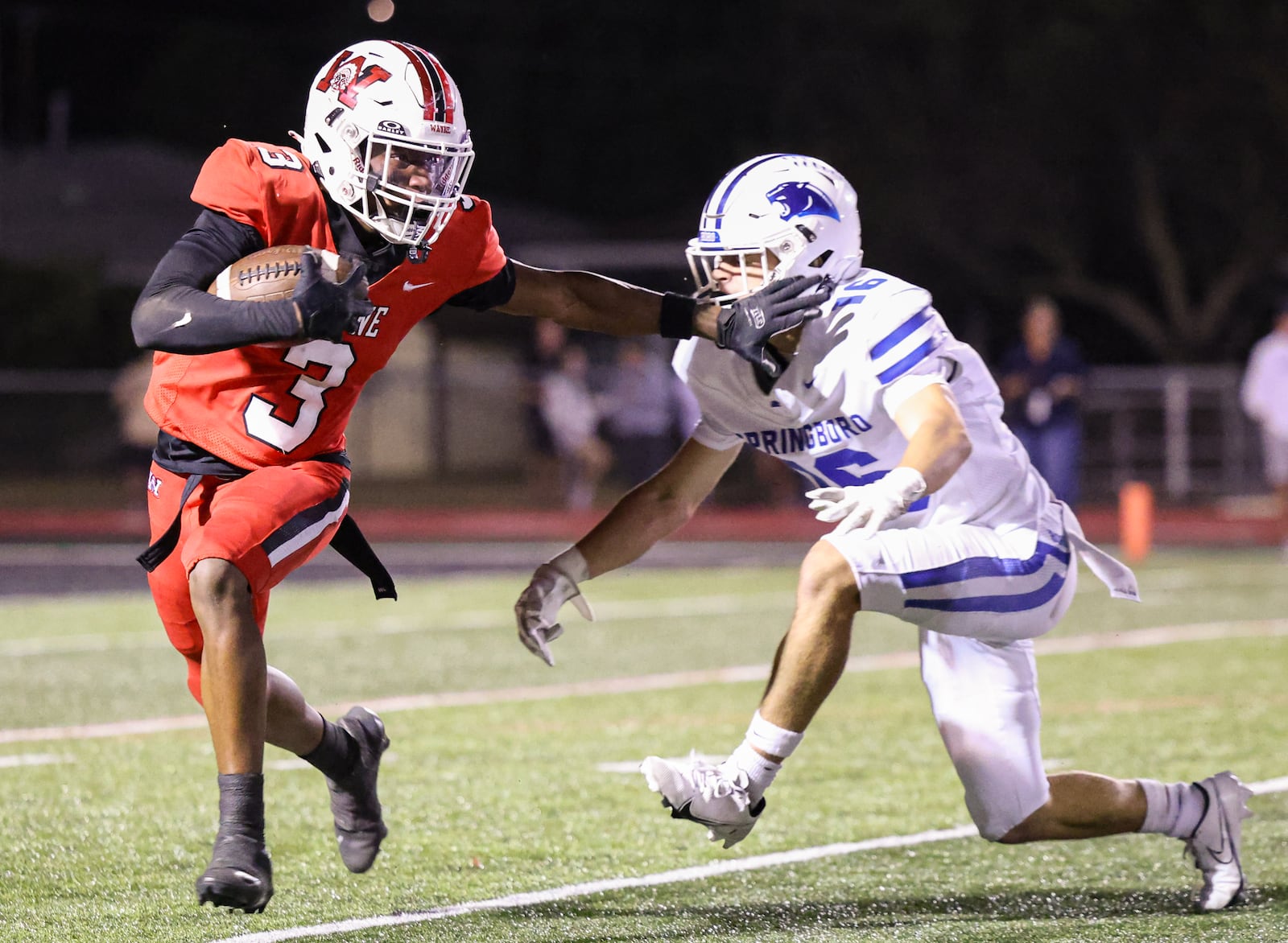 Wayne sophomore quarterback Kye Graham runs with pressure from Springboro's Cole Henson during a Greater Western Ohio Conference game on Friday, Sept. 12 at Heidkamp Stadium. BRYANT BILLING / STAFF