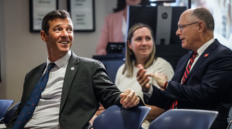 Ohio's interim superintendent of public instruction Chris Woolard, left, speaks with University of Dayton president Eric Spina, right. Both attended a press conference at the University of Dayton Wednesday, Aug. 16 where Governor Mike DeWine announced a new reading initiative for Ohio students. JIM NOELKER/STAFF