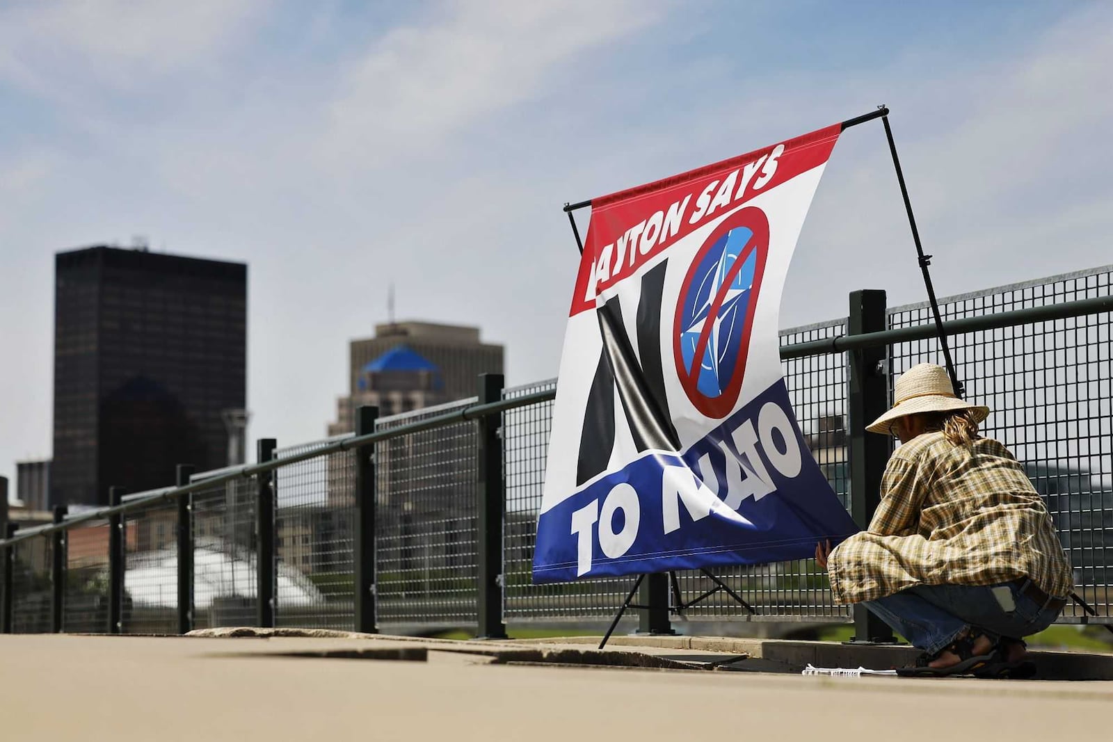 Protesters gathered at Deeds Point in Dayton across the Great Miami River from the security zone of the NATO Parliamentary Assembly on Saturday, May 24, 2025. NICK GRAHAM / STAFF