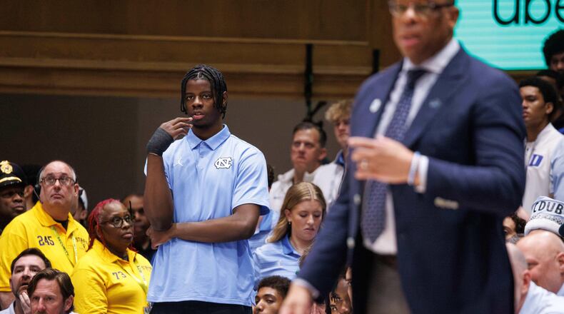 North Carolina's Caleb Wilson,left, who is injured, watches from the bench before an NCAA college basketball game against Duke in Durham, N.C., Saturday, March 7, 2026. (AP Photo/Ben McKeown)