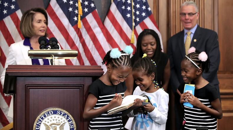 Shiloh Tappin (R), her twin sister Seilah Tappin (3rd R) and their friend Dani Hebron, all 7 years old, take notes during a news conference conducted by House Minority Leader Nancy Pelosi (D-CA) in the Rayburn Room at the U.S. Capitol November 3, 2017 in Washington, D.C. Virtually every Democrat opposed a GOP measure to extend the children’s health insurance program for five years because they say Republicans are using children’s health to chip away at the 2010 health law known as Obamacare. (Photo by Chip Somodevilla/Getty Images)