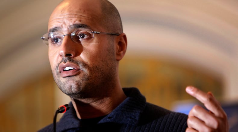 FILE - In this Feb. 25, 2011, file photo, Seif al-Islam Gadhafi speaks to the media at a press conference in a hotel in Tripoli, Libya. (AP Photo/Ben Curtis, File)