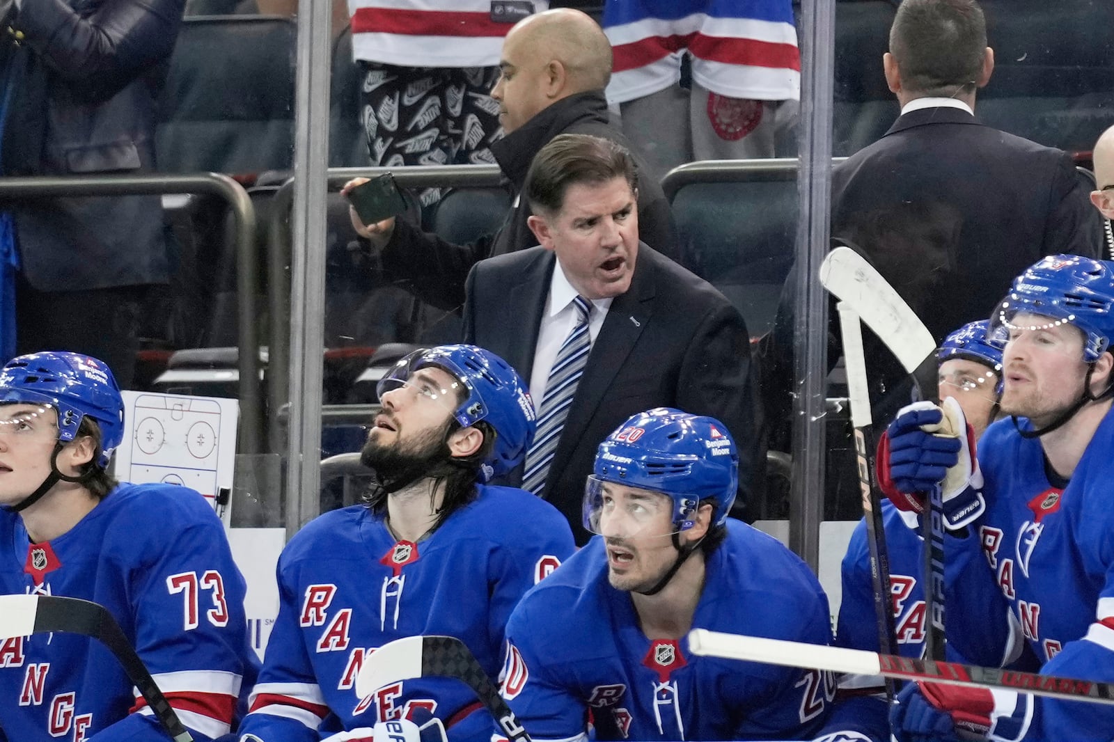 New York Rangers coach Peter Laviolette talks to this team during the second period of an NHL hockey game against the Tampa Bay Lightning in New York, Thursday, April 17, 2025. (AP Photo/Seth Wenig)