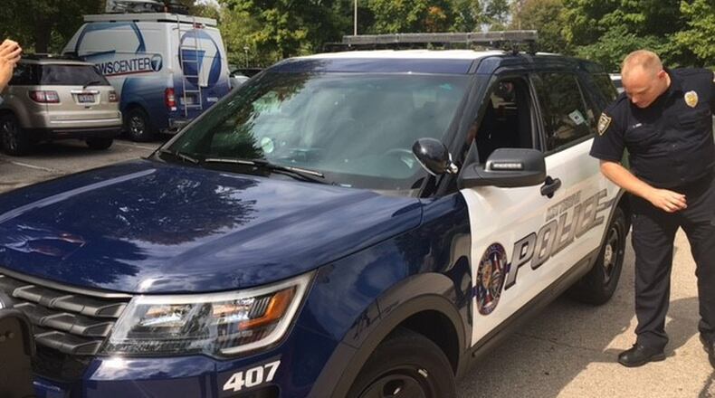 Officer John Jung with the Kettering Police Department explains the benefits of crusier cameras to the police force. TREMAYNE HOGUE/STAFF