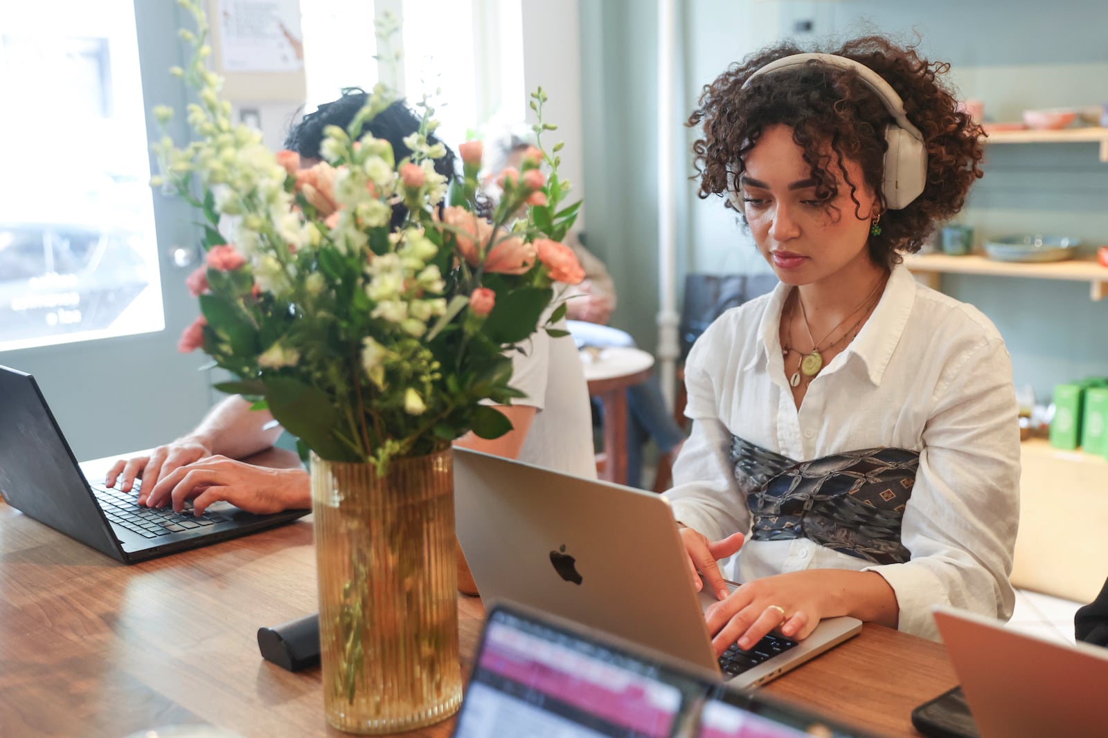 Summer Dean, 27, works inside a coffee shop, Friday, May 23, 2025, in New York. (AP Photo/Heather Khalifa)