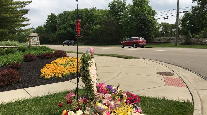 A floral memorial has taken shape across from where a traffic accident a week ago resulted in the death of a Butler County woman assisting crash victims. Staff photo by Lawrence Budd