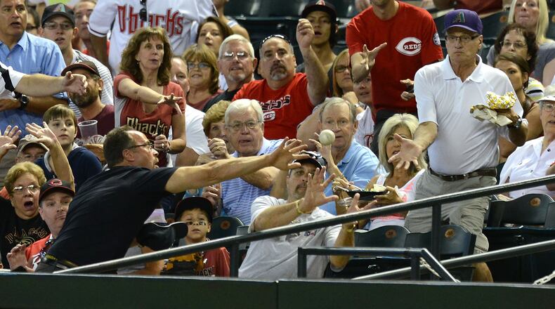 PHOENIX, AZ - JUNE 23: Fans try to catch a foul ball during a game between the Arizona Diamondbacks and the Cincinnati Reds at Chase Field on June 23, 2013 in Phoenix, Arizona. (Photo by Norm Hall/Getty Images)