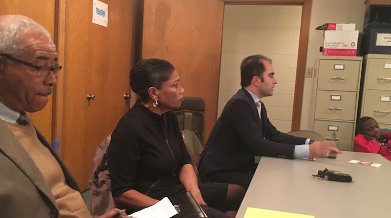 Dayton school board President Adil Baguirov (right) addresses a group of parents and community residents Thursday night, Dec. 1, 2016, as board members Hazel Rountree (center) and Robert Walker look on. (Jeremy P. Kelley/Staff)
