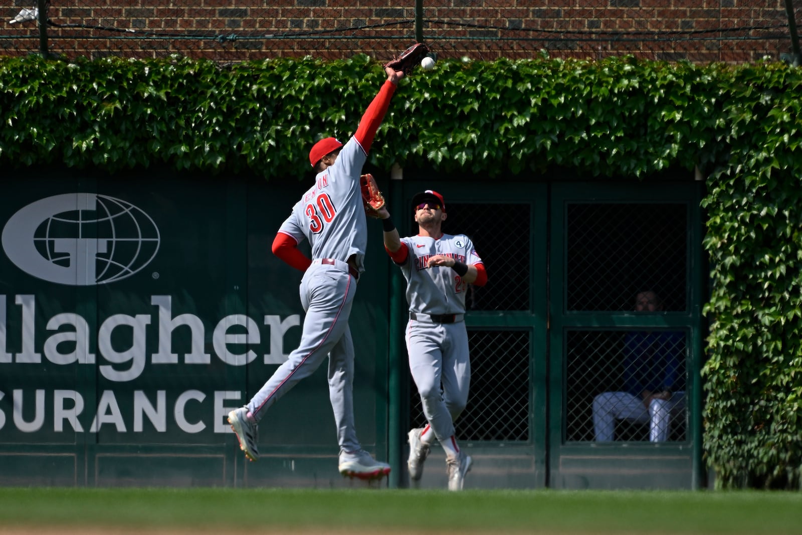 Cincinnati Reds outfielder Will Benson (30) cannot catch a double hit by Chicago Cubs' Pete Crow-Armstrong during the seventh inning of a baseball game, Sunday, June 1, 2025, in Chicago. (AP Photo/Matt Marton)