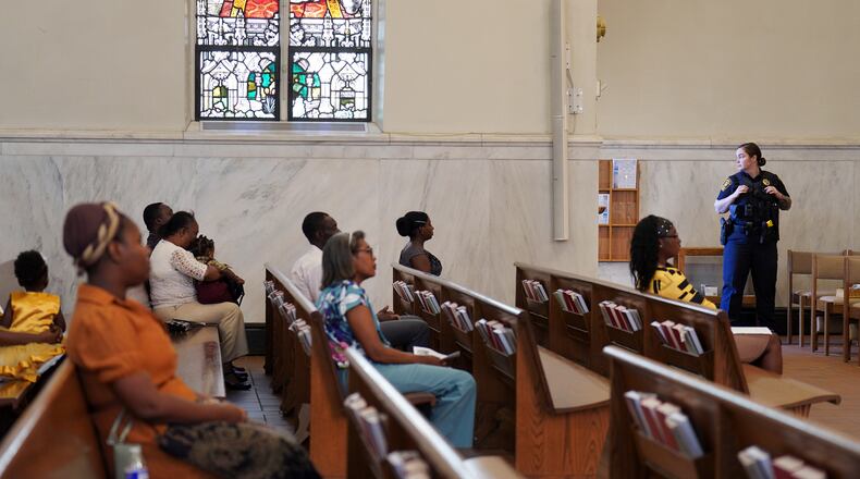 A Springfield police officer stands watch during a service in support of the Haitian community at St. Raphael Catholic church in Springfield, Ohio, Sunday, Sept. 15, 2024. (AP Photo/Jessie Wardarski)