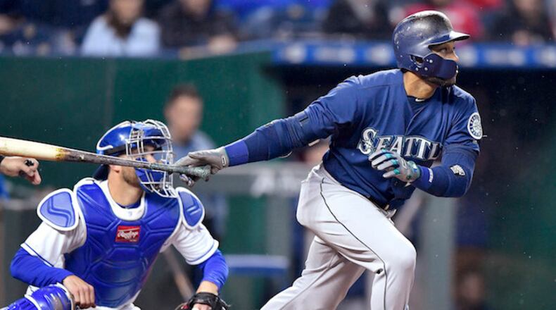 Seattle Mariners' Robinson Cano follows through on an RBI double to score Jean Segura in the second inning against the Kansas City Royals on Tuesday, April 10, 2018, at Kauffman Stadium in Kansas City, Mo. (John Sleezer/Kansas City Star/TNS)