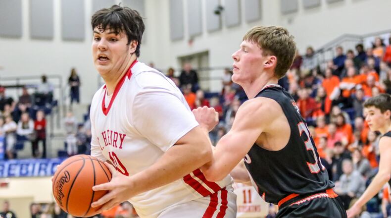 Cutline: St. Henry High School senior Caden Niekamp is guarded by Jackson Center’s Aidan Reichert during a Division IV regional final game at Kettering Fairmont’s Trent Arena on March 15. The Redskins (24-3) advanced to the state tournament for the first time since 2004. They’ll play Berlin Hiland (27-1) in the D-IV state semifinals at noon Friday in Columbus. CONTRIBUTED PHOTO BY MICHAEL COOPER