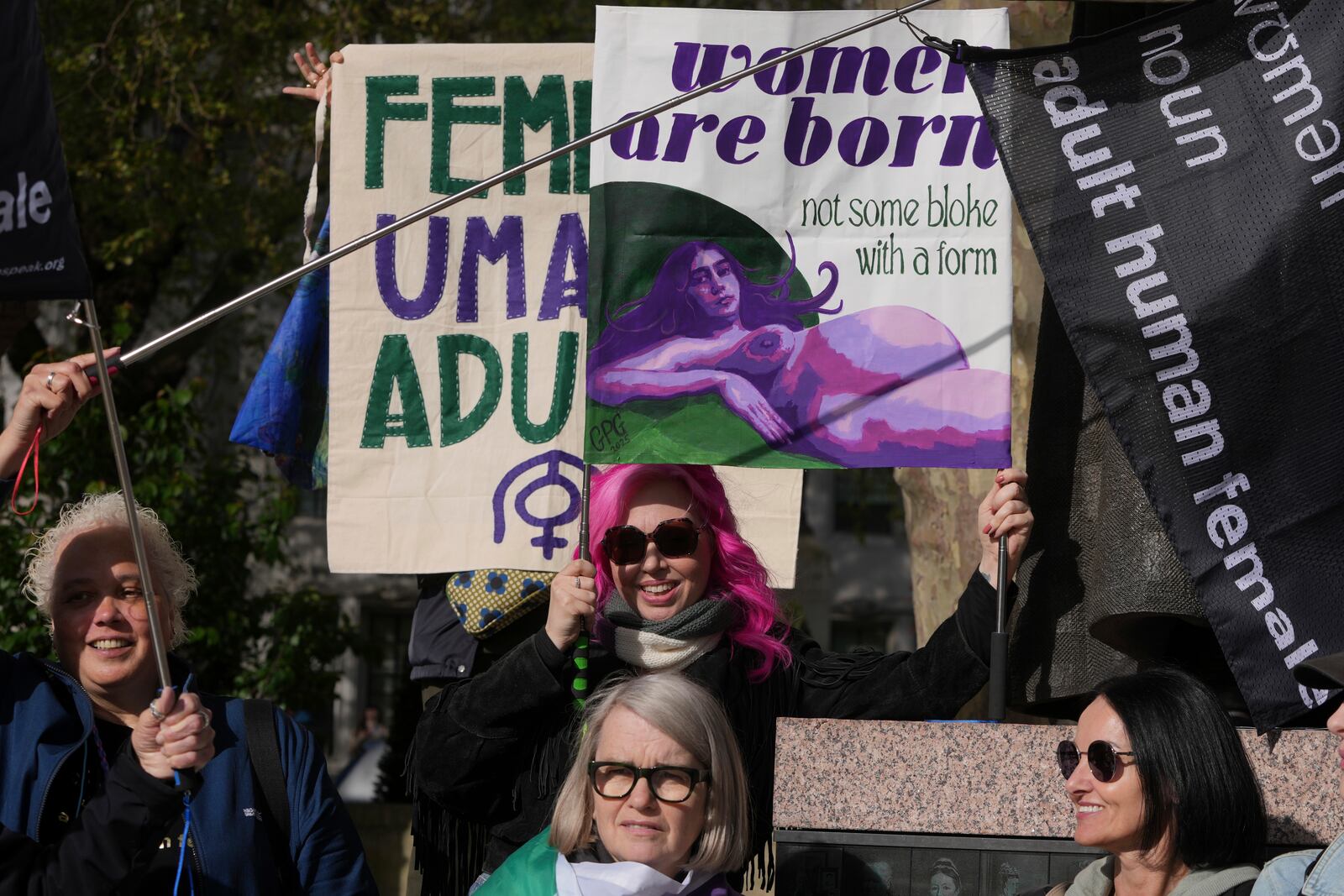 Women's rights activists hold placards outside the Supreme Court to challenge gender recognition laws, in London, Wednesday, April 16, 2025. (AP Photo/Kin Cheung)