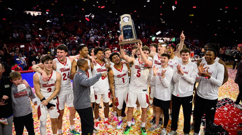 The Miami University men's basketball team hoists the Mid-American Conference trophy after beating Toledo 74-72 on Tuesday, March 3, 2026 at Millett Hall. JEREMY MILLER / CONTRIBUTED PHOTO