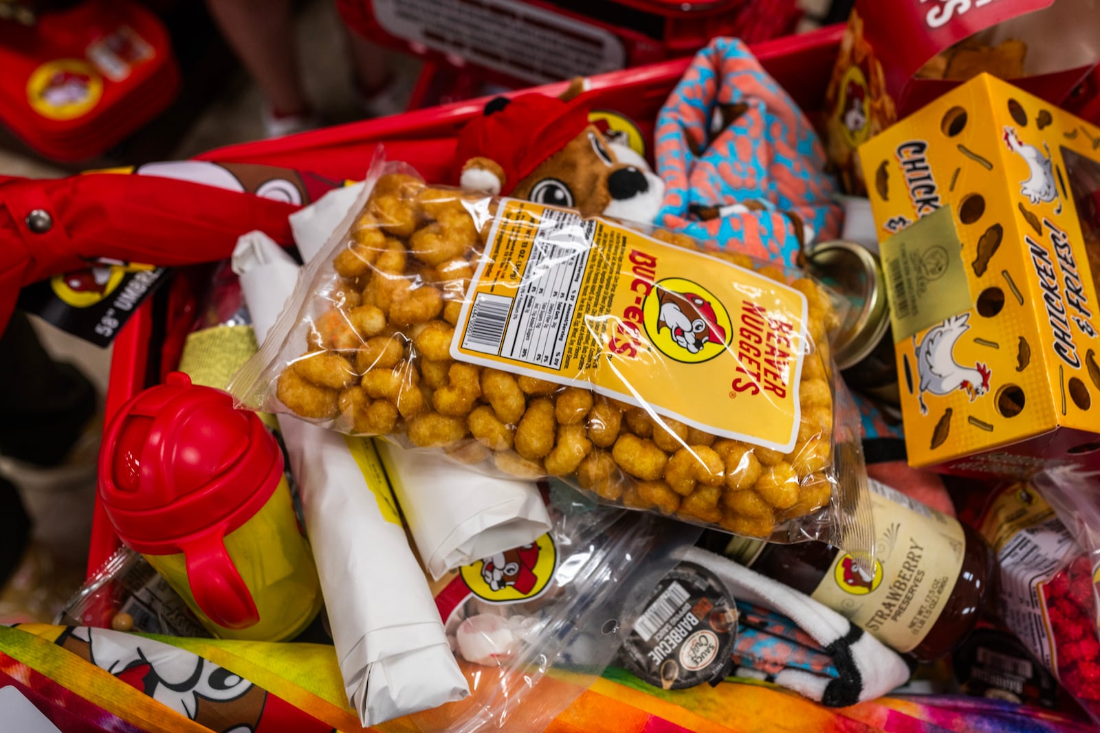 
                        People load their carts with Buc-ee’s snacks and merchandise during the grand opening of a Buc-ee’s in Pass Christian, Miss., on June 9, 2025. The opening of the first location in Mississippi drew the usual cultish enthusiasm for the chain of mega convenience stores. (Emily Kask/The New York Times)
                      
