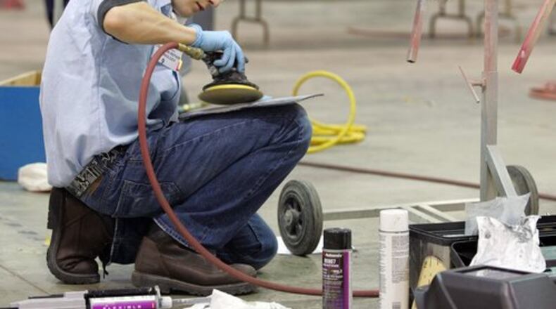 Kyle Railsback of the Miami Valley Career Technology Center sands a panel during the collision repair technician SkillsUSA competition. FILE